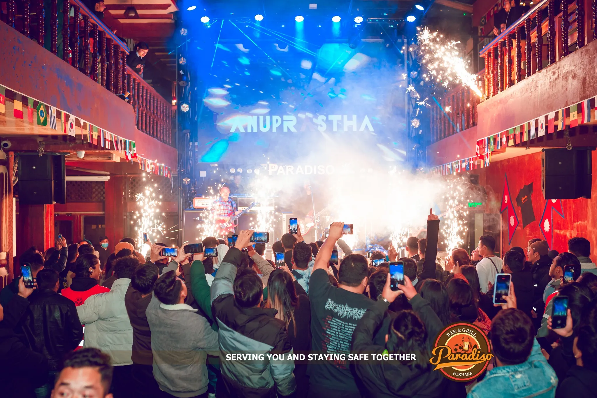 Anuprastha on the Paradiso stage, sparklers going off and the crowd filming